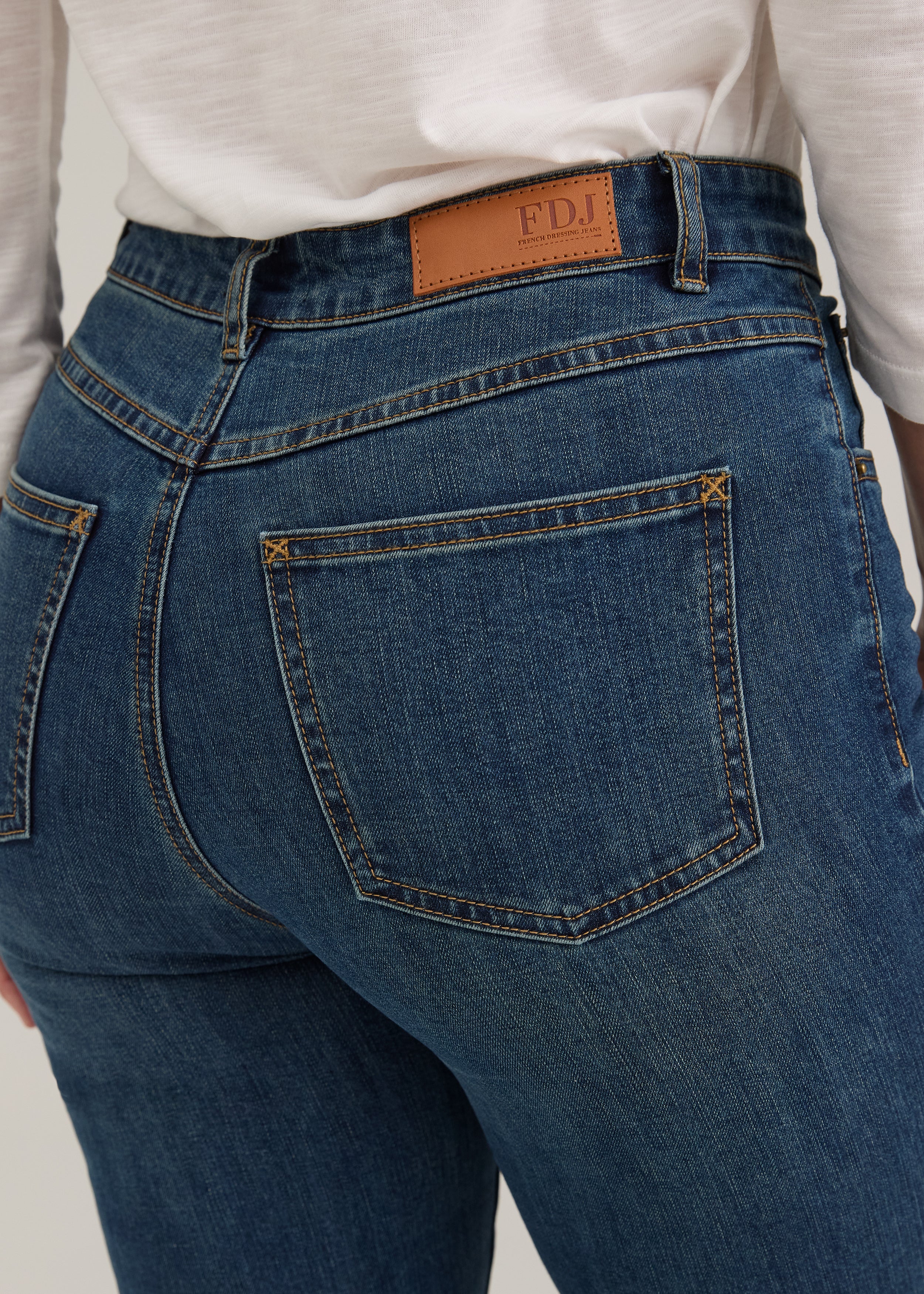 Detail shot of back pocket stitching and FDJ label on dark wash jeans by French Dressing Jeans (FDJ)