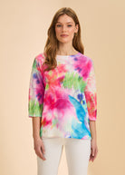 Front view of vibrant floral 3/4 sleeve top with white pants by French Dressing Jeans (FDJ)