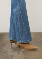 Side view of medium wash denim pants highlighting bootcut design and hem details by French Dressing Jeans (FDJ) par French Dressing Jeans (FDJ)