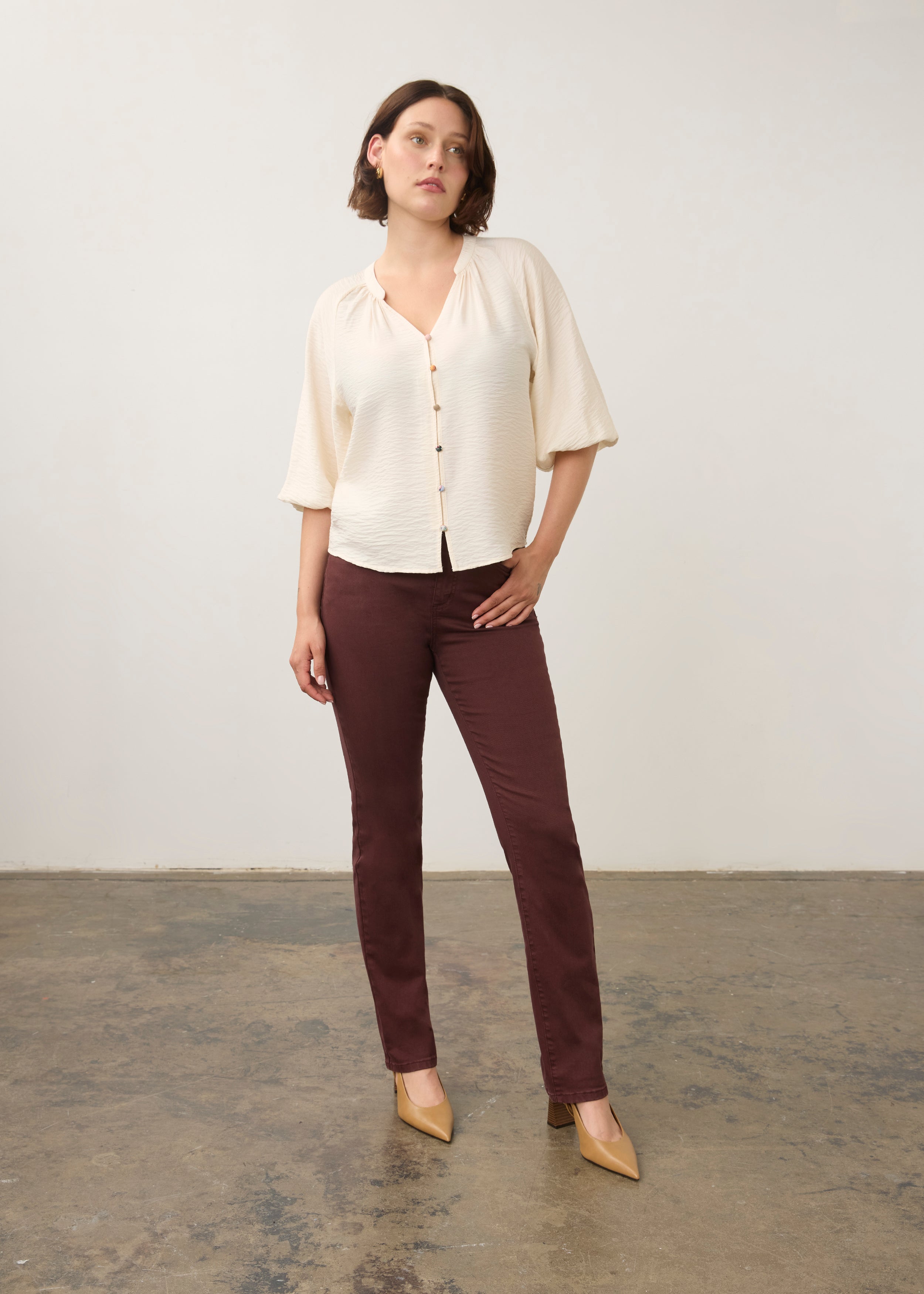 Model in cream blouse and maroon pants, full body view by French Dressing Jeans (FDJ)
