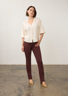 Model in cream blouse and maroon pants, full body view by French Dressing Jeans (FDJ)