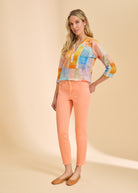 Full-length view of pastel patchwork top with orange jeans by French Dressing Jeans (FDJ)