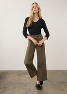 Full body view of black V-neck top paired with wide-leg pants by French Dressing Jeans (FDJ)