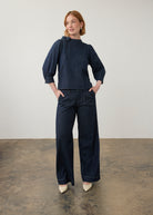 Full view of dark wash denim set with puff-sleeve top and wide-leg pants by French Dressing Jeans (FDJ)
