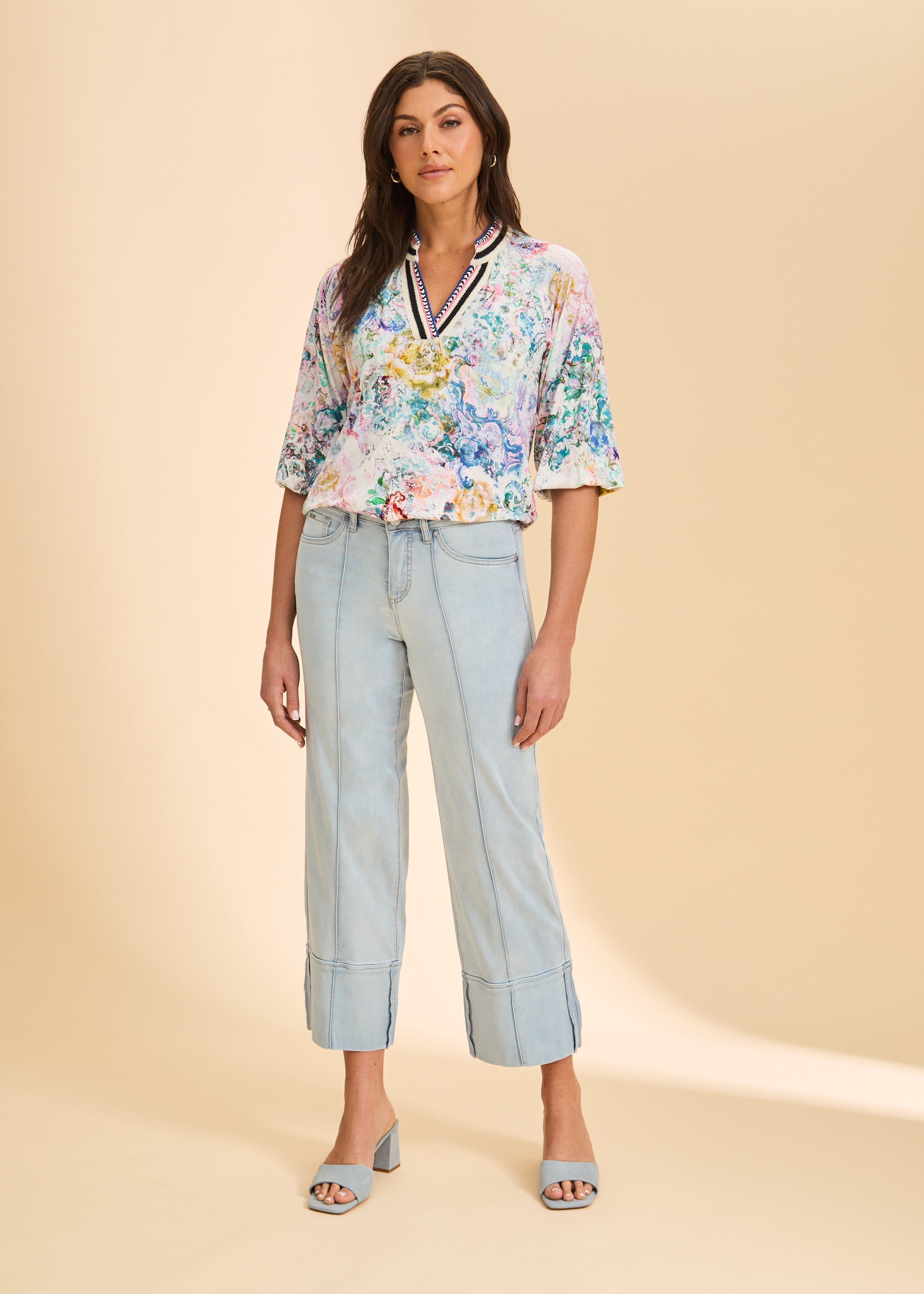 Full body view of light wash wide-leg denim pants with a floral top by French Dressing Jeans (FDJ)