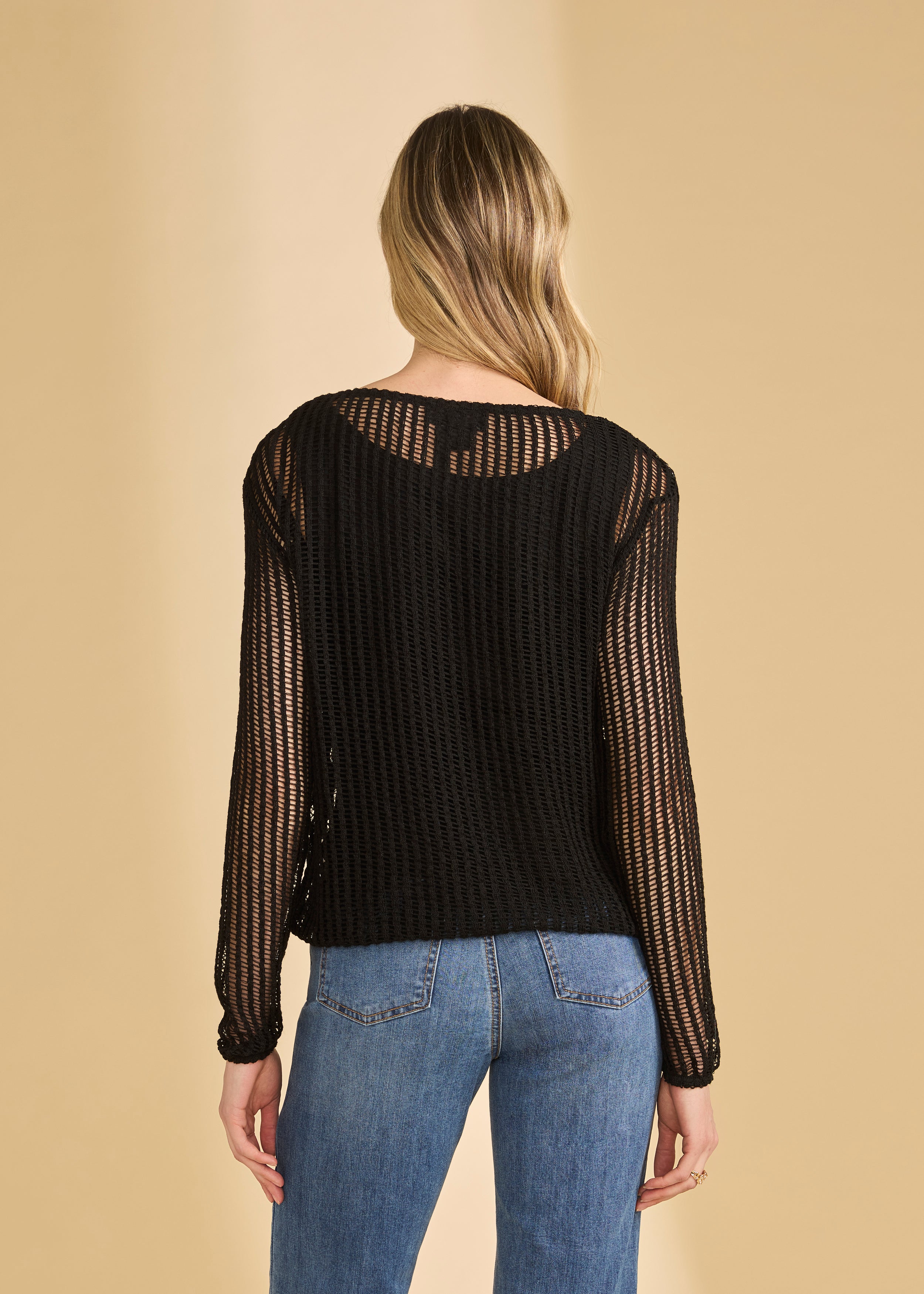 Back view of black mesh top showing sheer design and long sleeves by French Dressing Jeans (FDJ)