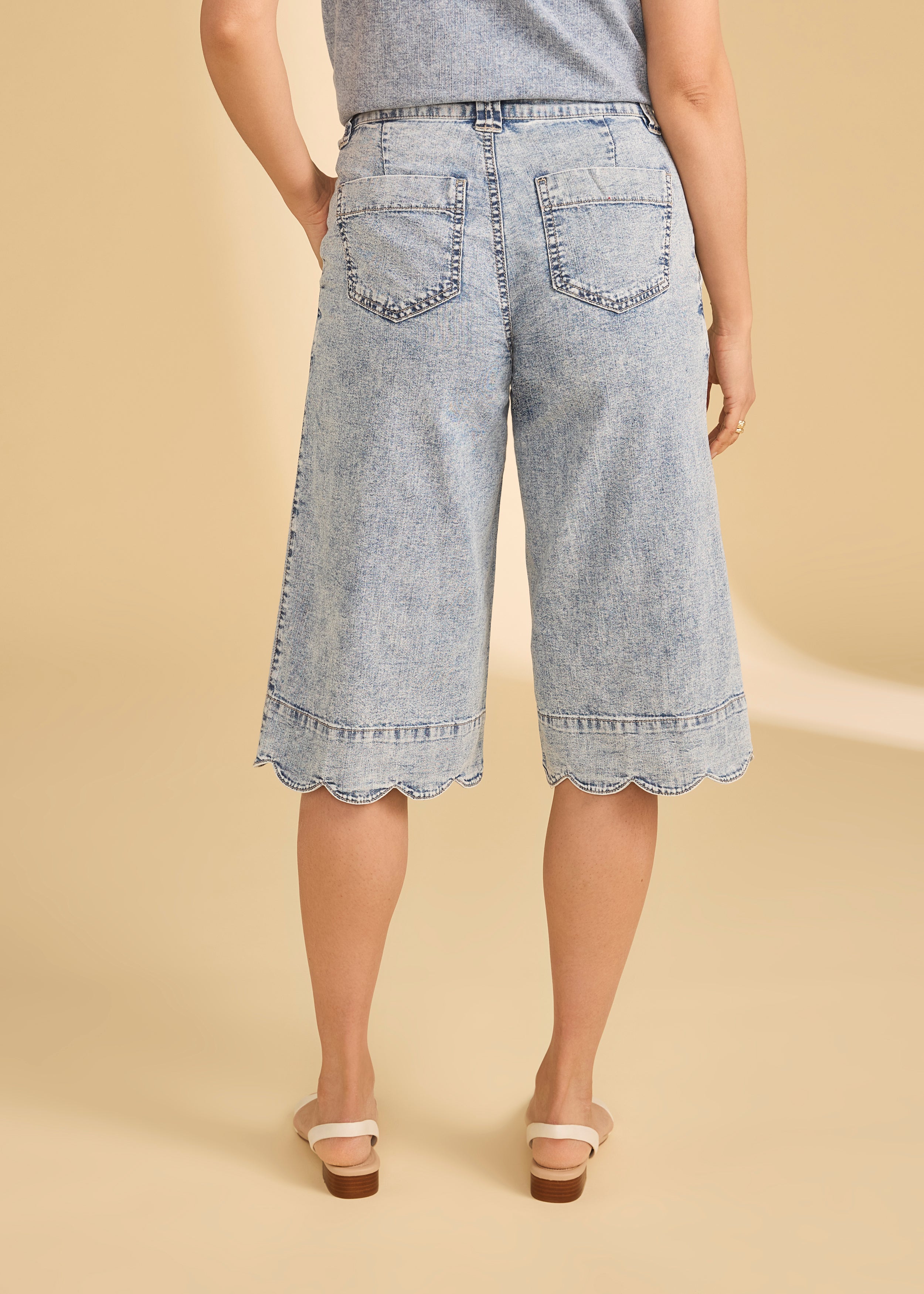 Back view of powder wash denim shorts displaying back pockets and scalloped hem by French Dressing Jeans (FDJ)