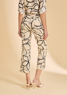 Back view of beige plumeria crop pants showing patch pockets and floral print by French Dressing Jeans (FDJ)