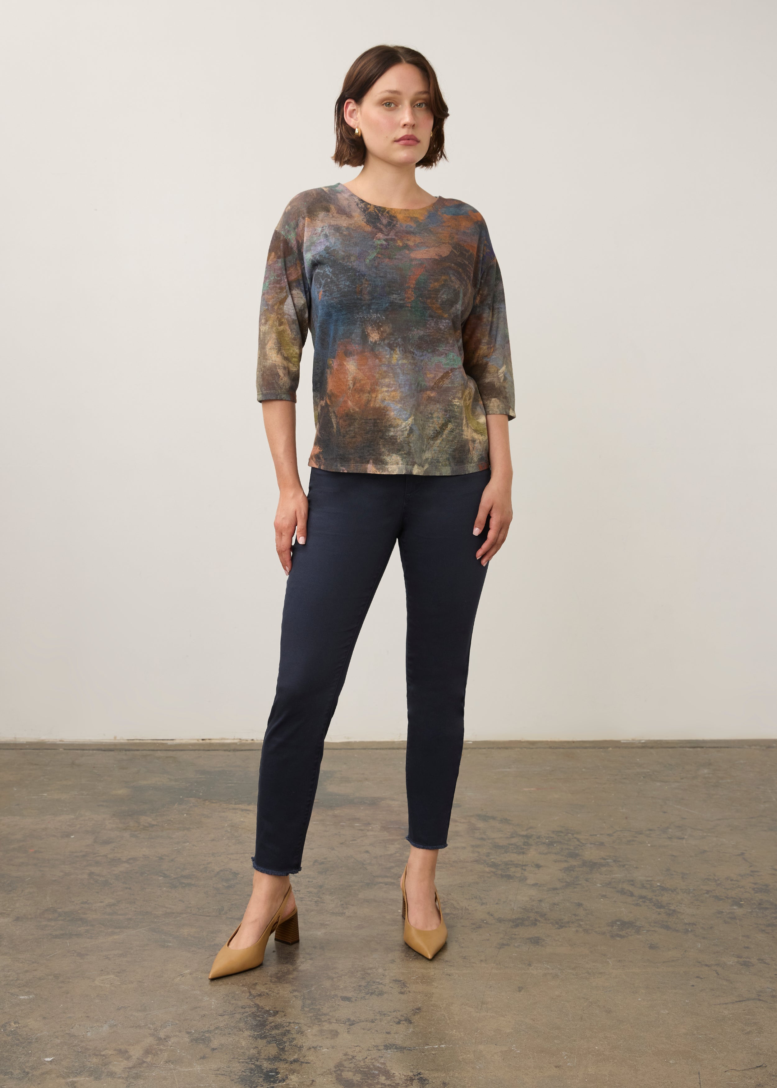 Full body view of earthy-toned Henley top styled with navy pants and heels by French Dressing Jeans (FDJ)