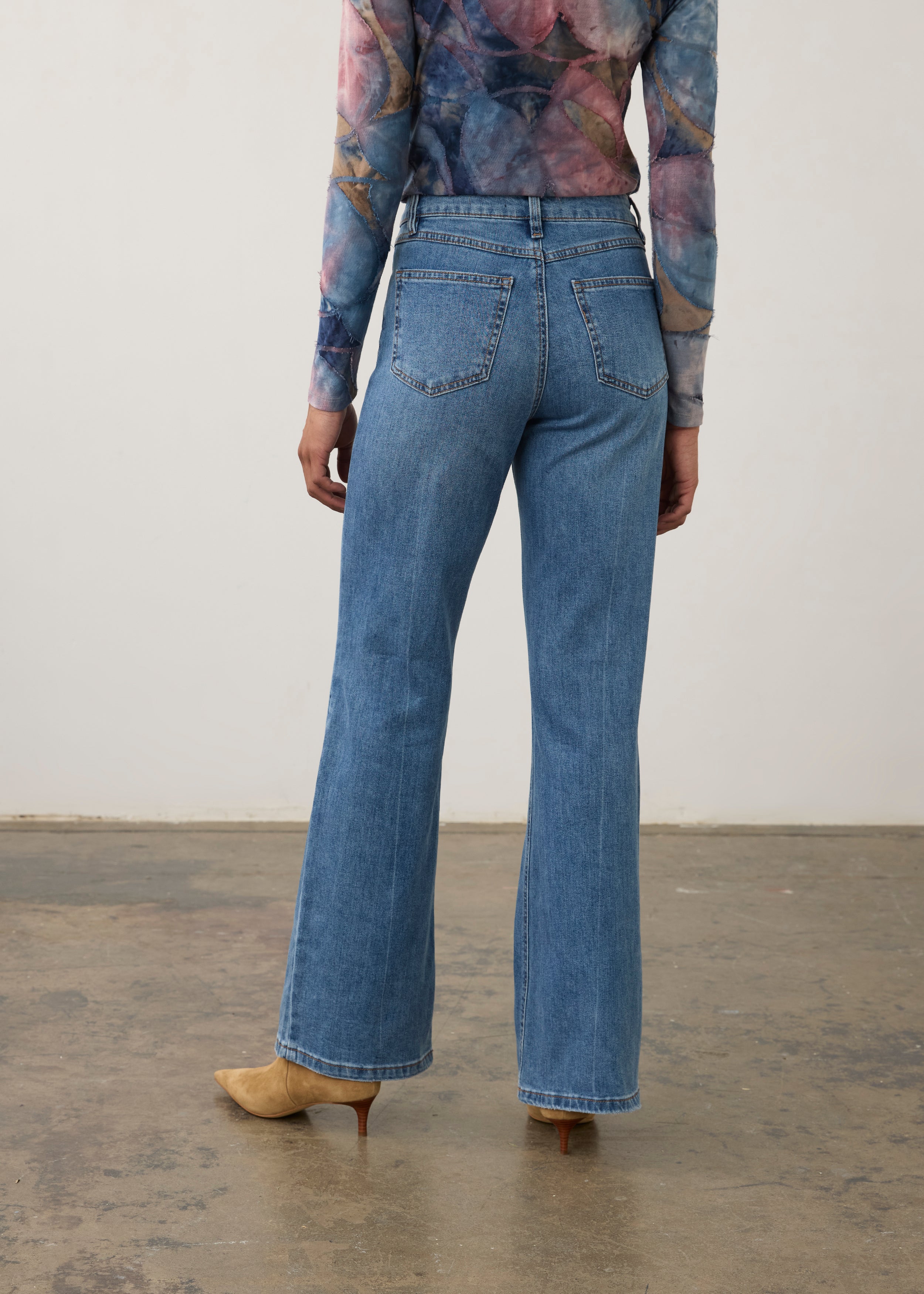 Back view of medium wash denim pants featuring back patch pockets and bootcut leg by French Dressing Jeans (FDJ) par French Dressing Jeans (FDJ)