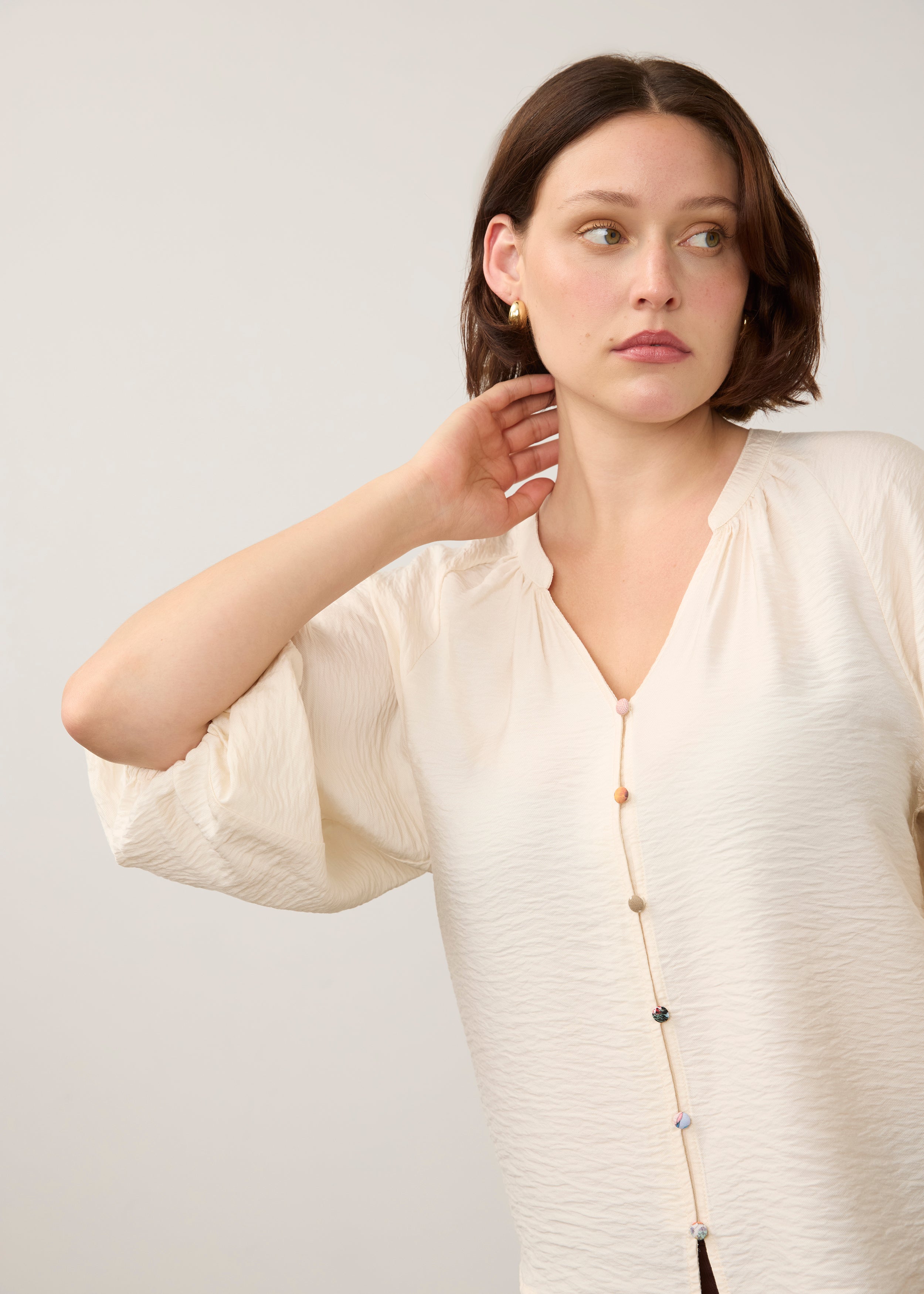 Close-up of cream blouse emphasizing colorful buttons by French Dressing Jeans (FDJ)