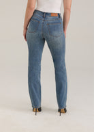 Back view of Olivia straight leg jeans in light wash featuring back pockets and mid-rise design by French Dressing Jeans (FDJ)
