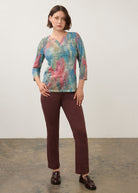 Full body view of pastel Henley top paired with burgundy pants and loafers by French Dressing Jeans (FDJ)