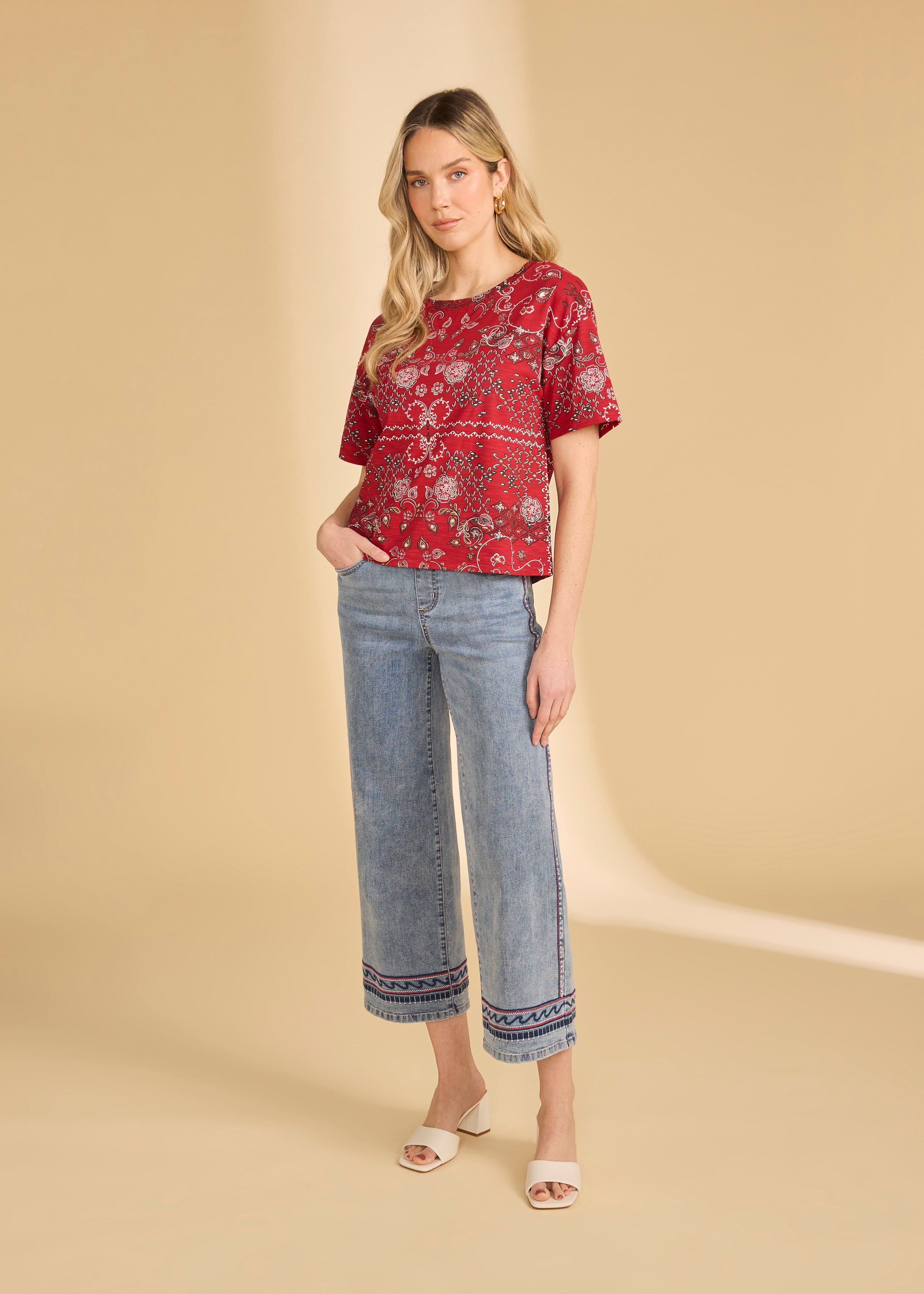 Model in light medium pull-on wide ankle denim with embroidered hem and red printed blouse by French Dressing Jeans (FDJ)