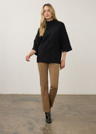 Full view of black tunic sweater with tan pants and boots by French Dressing Jeans (FDJ)