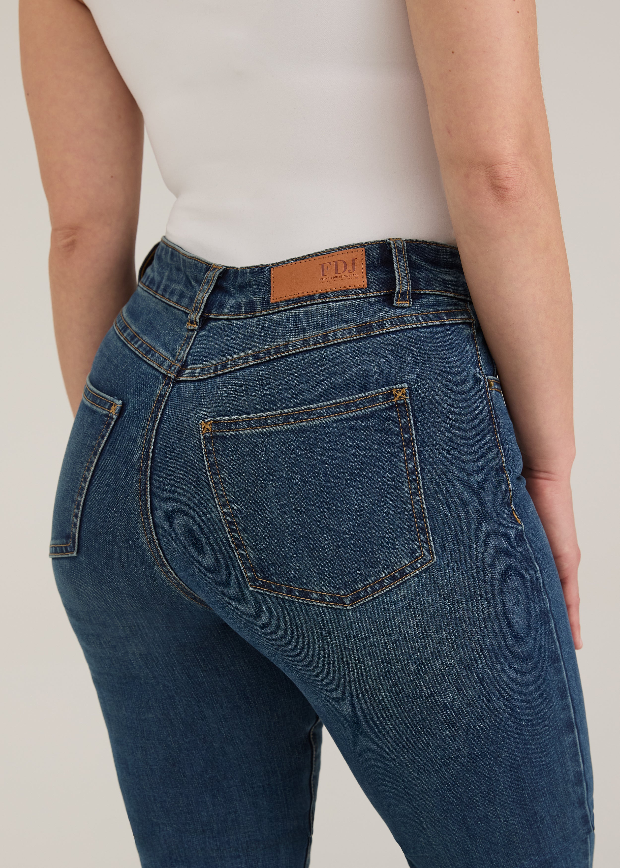 Detail of FDJ label and back pocket stitching on dark wash jeans by French Dressing Jeans (FDJ)