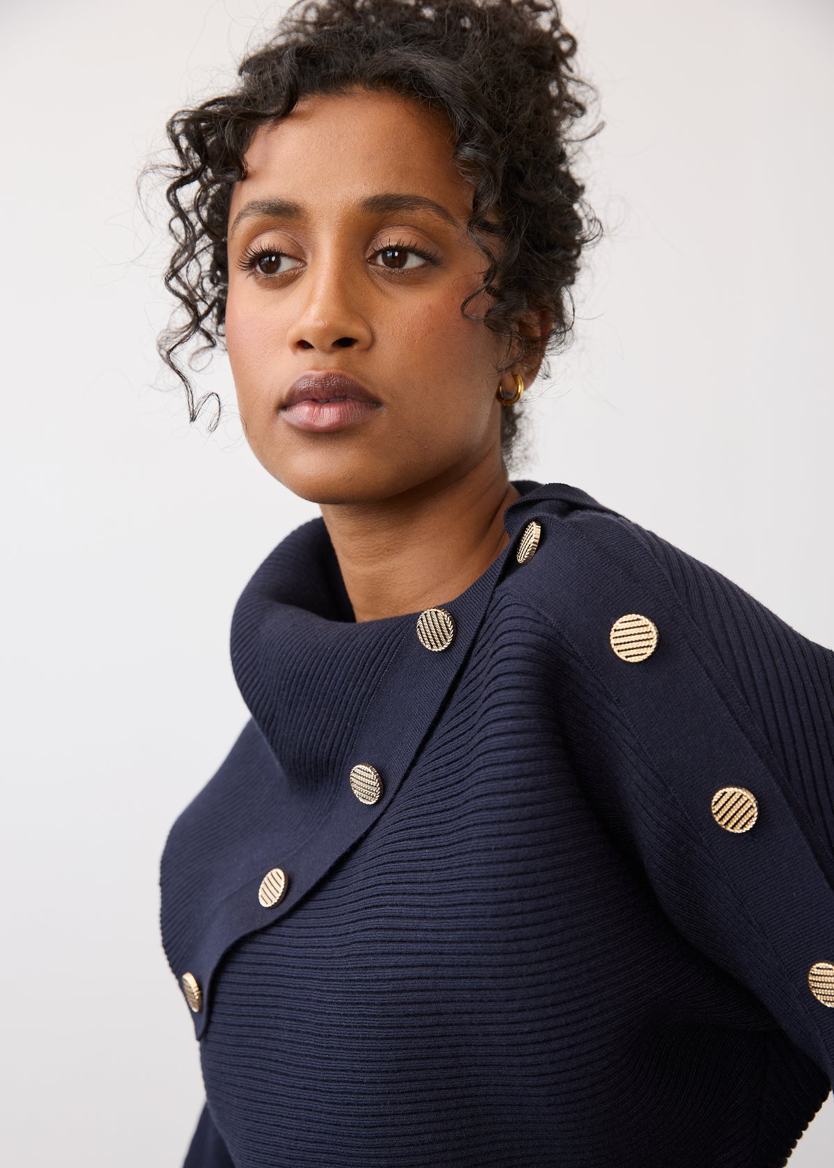 Close-up of navy sweater showing button accents on shoulder by French Dressing Jeans (FDJ)