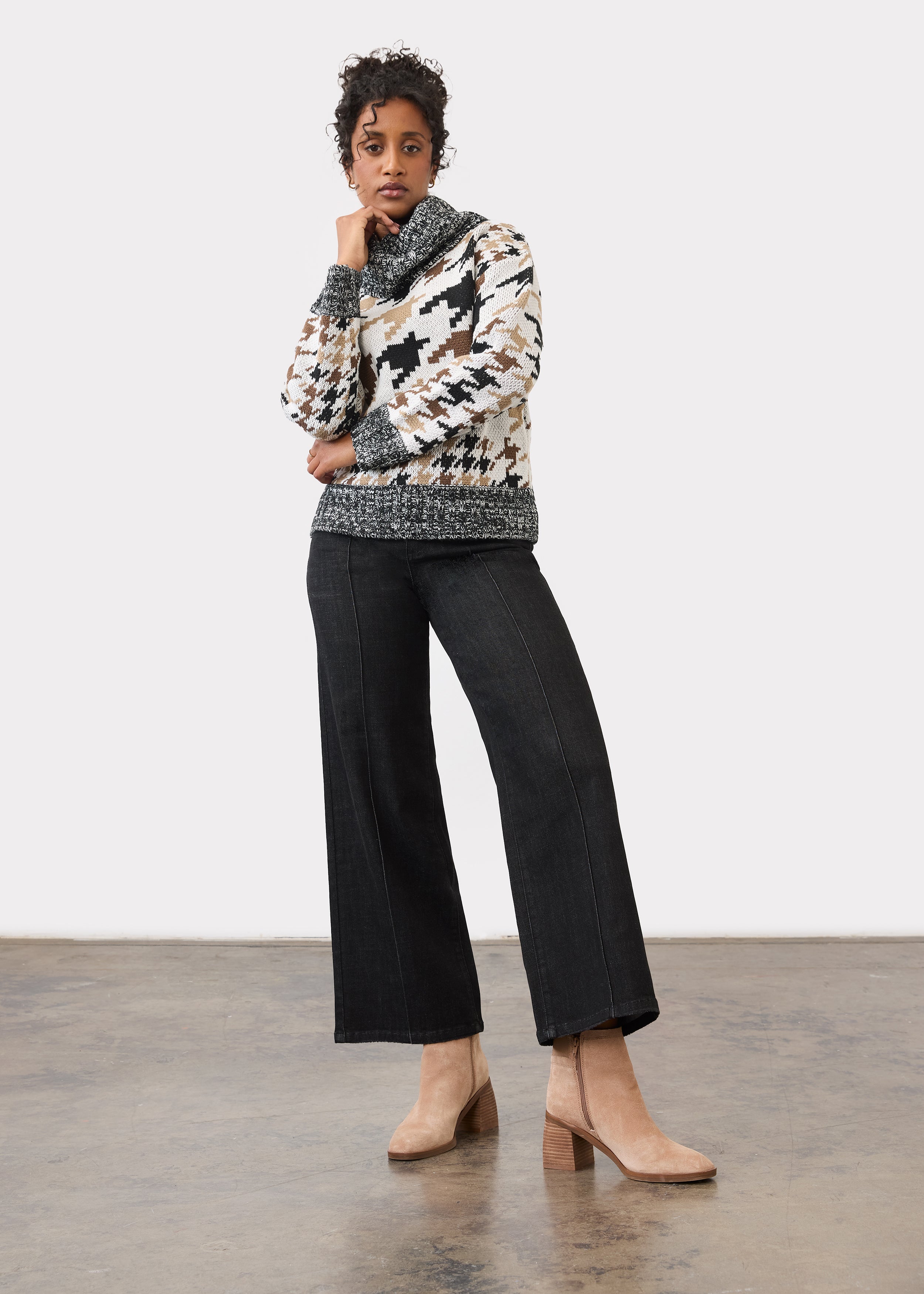 Full body view of black wide-leg jeans paired with patterned sweater by French Dressing Jeans (FDJ)