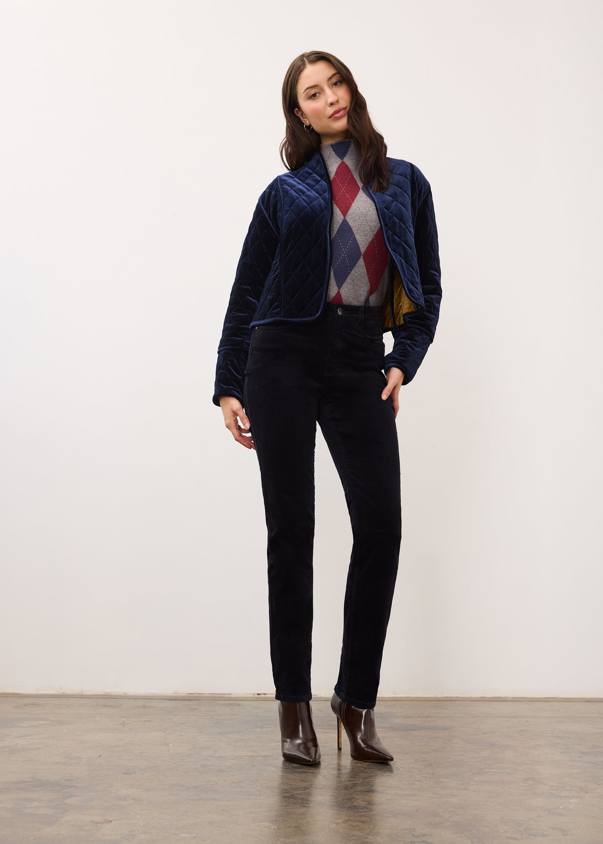 Full-body view of quilted jacket in blueberry, paired with dark pants and boots by French Dressing Jeans (FDJ)