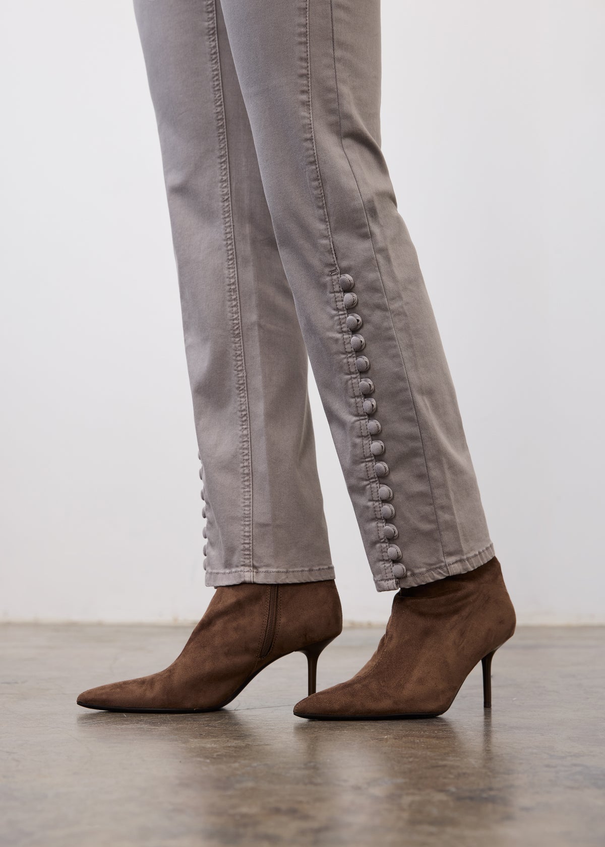 Side profile of gray pencil leg denim highlighting button details on seam by French Dressing Jeans (FDJ)