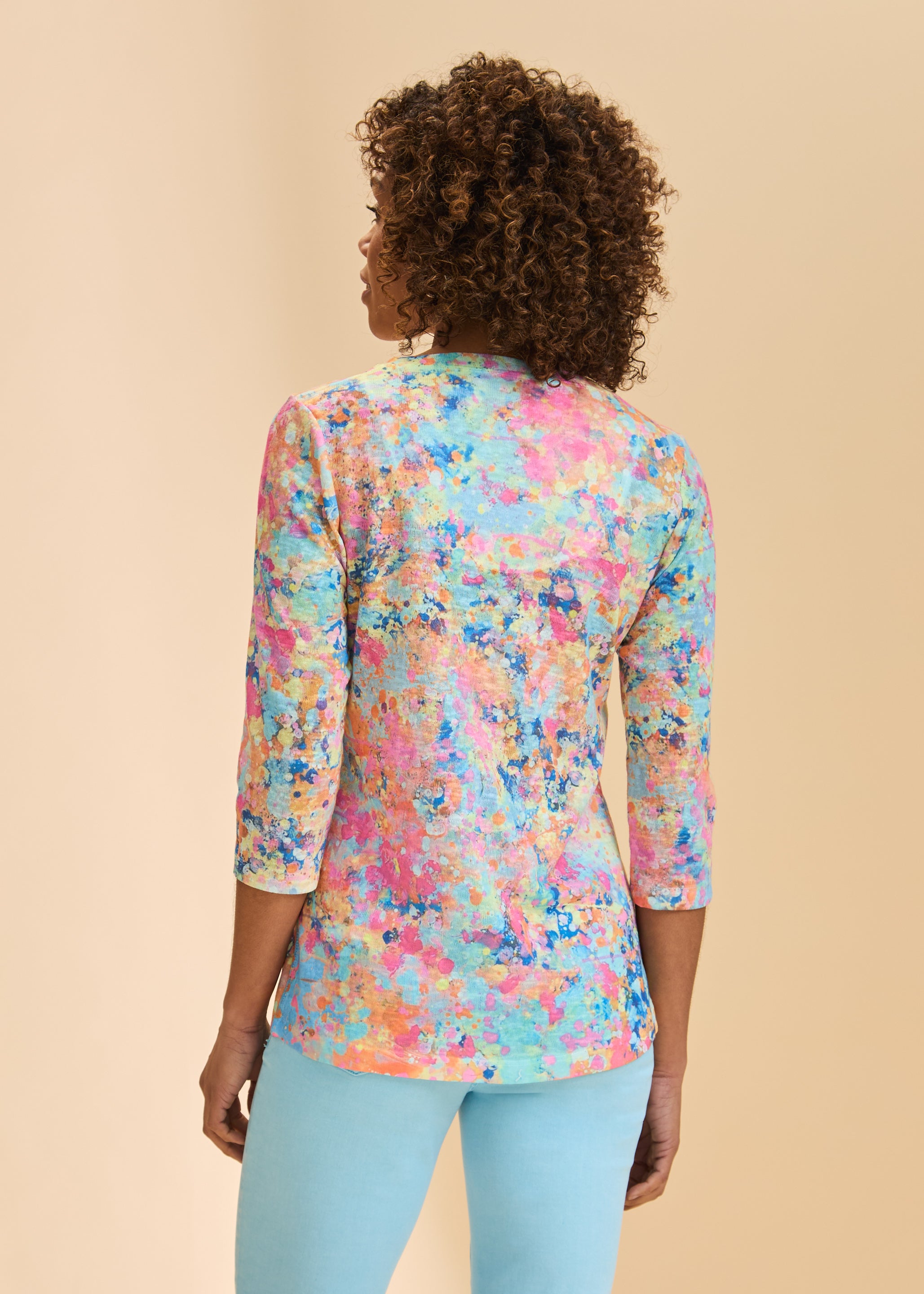 Back view showing 3/4 sleeves and vibrant abstract pattern on V-neck top by French Dressing Jeans (FDJ)