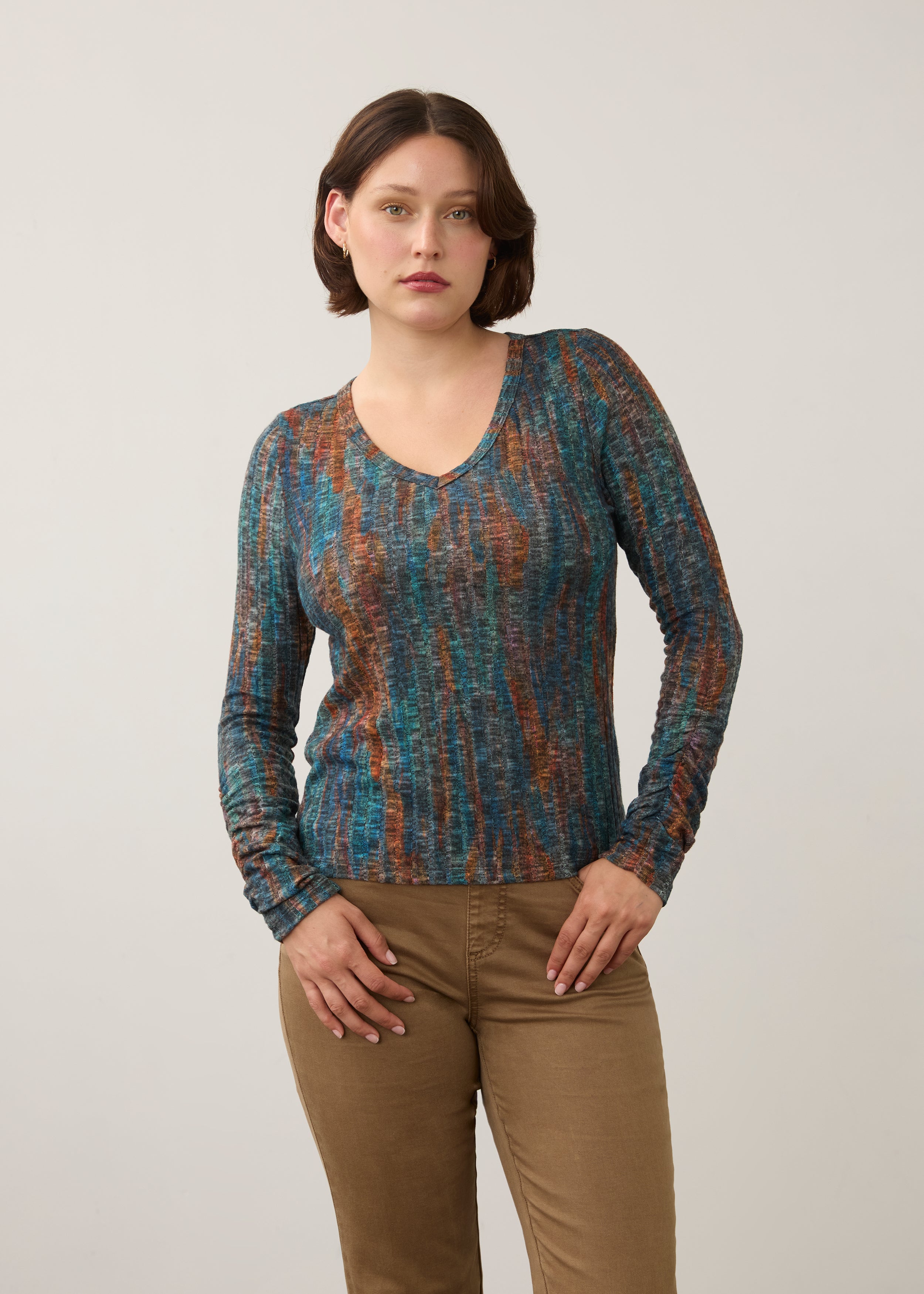 Front view of striped V-neck top in earthy tones, paired with beige pants by French Dressing Jeans (FDJ)