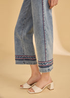 Side view highlighting the embroidered hem on wide leg light medium denim by French Dressing Jeans (FDJ)