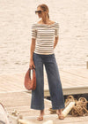 Striped top with wide-leg blue denim pants on a dock by French Dressing Jeans (FDJ)