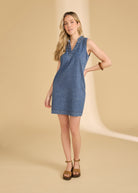 Front view of sleeveless denim dress with V-neck, styled with wedges by French Dressing Jeans (FDJ)